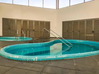 a large swimming pool in a building with aurned at Sunrise Serenity at Palas Horizon Residence in Brinchang