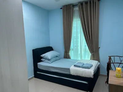 a blue room with a bed with a window at Hazel Luxe Apartment in Permatang Pauh