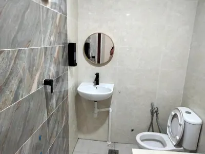 a bathroom with a sink and a toilet and a mirror at LE dEON HOTEL Former Pine Hotel in Batu Gajah