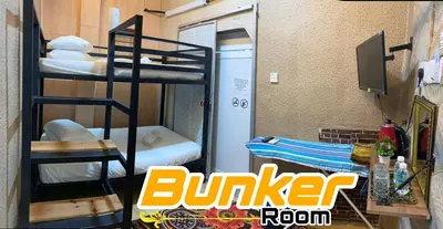 a dorm room with a bunk bed and a bunker at LE dEON HOTEL Former Pine Hotel in Batu Gajah