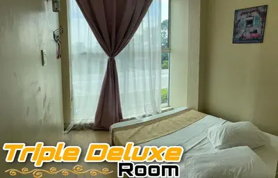 a bedroom with a bed and a window at LE dEON HOTEL Former Pine Hotel in Batu Gajah