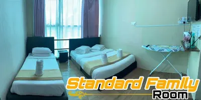 a hotel room with two beds and a balcony at LE dEON HOTEL Former Pine Hotel in Batu Gajah