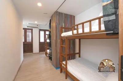 a hallway with two bunk beds in a room at Parlor Hotel in Ipoh