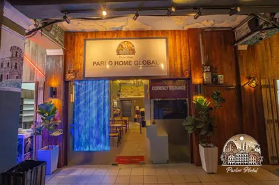 a restaurant entrance with a sign that reads paro home global at Parlor Hotel in Ipoh