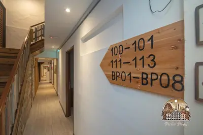 a sign on the side of a building with a hallway at Parlor Hotel in Ipoh