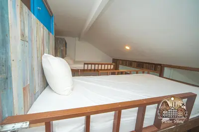 a bedroom with a large bed in a room at Parlor Hotel in Ipoh
