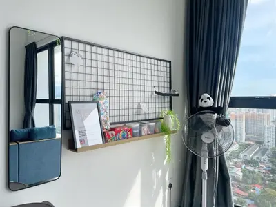a room with a window with a fan and a mirror at 3B2R 2CarPark Tea Time Suite with Infinity Pool in Jelutong