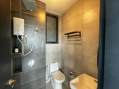 a bathroom with a toilet and a sink at 3B2R 2CarPark Tea Time Suite with Infinity Pool in Jelutong