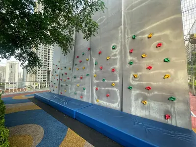 a wall with a climbing wall with a blue bench at 3B2R 2CarPark Tea Time Suite with Infinity Pool in Jelutong