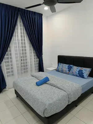 a bedroom with a bed with a blue pillow on it at Dream Anderson Condo in Ipoh