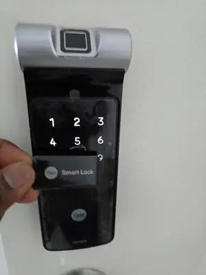 a person holding a smart phone in their hand at Dream Anderson Condo in Ipoh