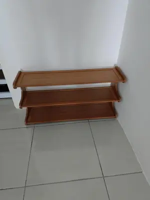 a wooden shelf in a room with a tile floor at Dream Anderson Condo in Ipoh