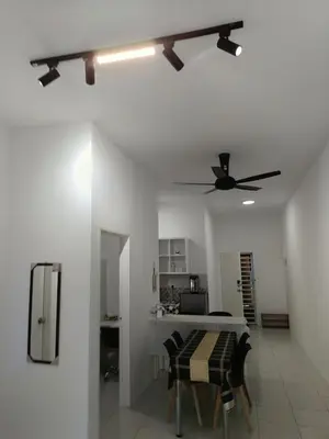 a living room with a ceiling fan and a table at Dream Anderson Condo in Ipoh