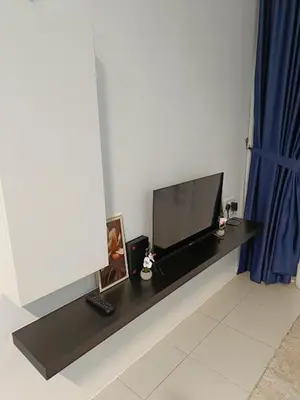 a television sitting on top of a black table at Dream Anderson Condo in Ipoh