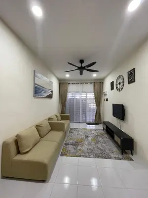 a living room with a couch and a ceiling fan at mOmma's Homestay in Seri Iskandar