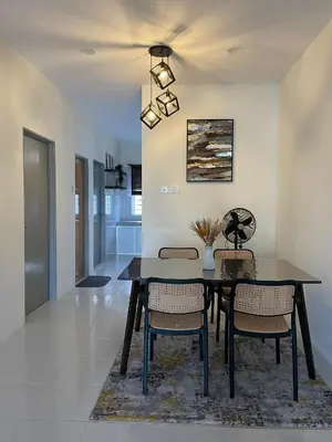 a dining room with a table and chairs at mOmma's Homestay in Seri Iskandar