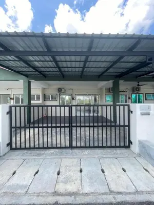 a patio with a fence and awning on a house at mOmma's Homestay in Seri Iskandar
