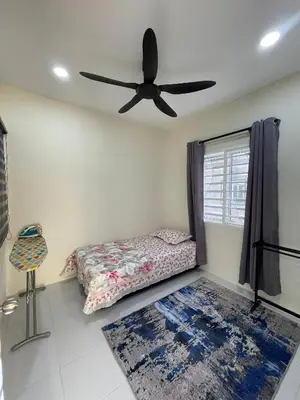 a bedroom with a bed and a ceiling fan at mOmma's Homestay in Seri Iskandar