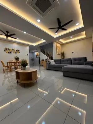 a living room with couches and a table in a room at Mia homestay in Teluk Intan
