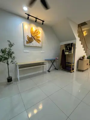 a room with a bench and a painting on the wall at Mia homestay in Teluk Intan