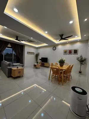 a living room with a table and a couch at Mia homestay in Teluk Intan