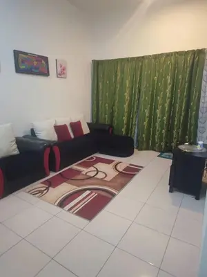 a living room with a couch and green curtains at AMRI KLATE Homestay in Seri Iskandar