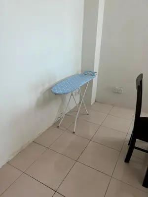 a small blue chair in a corner of a room at AMRI KLATE Homestay in Seri Iskandar