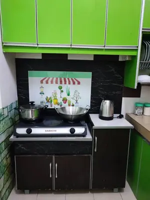 a kitchen with two pots and pans on a stove at AMRI KLATE Homestay in Seri Iskandar