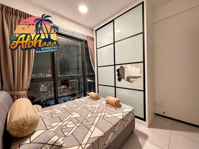 a bedroom with a large bed in front of a window at Urban Suite Modern Lifestyle Seaview Georgetown in Jelutong