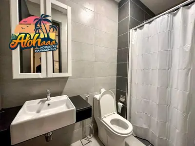 a bathroom with a sink and a toilet and a mirror at Urban Suite Modern Lifestyle Seaview Georgetown in Jelutong
