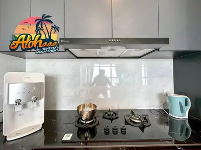 a kitchen with a stove top with a coffee maker at Urban Suite Modern Lifestyle Seaview Georgetown in Jelutong