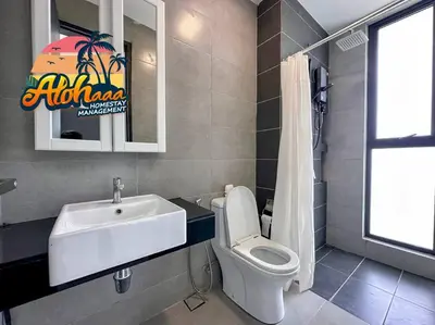 a bathroom with a sink and a toilet and a sink at Urban Suite Modern Lifestyle Seaview Georgetown in Jelutong