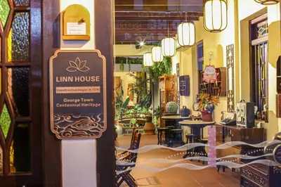 a sign on the door of a store with tables and chairs at LINN House Peranakan Residence George Town in George Town