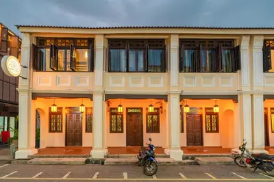 a building with motorcycles parked in front of it at LINN House Peranakan Residence George Town in George Town