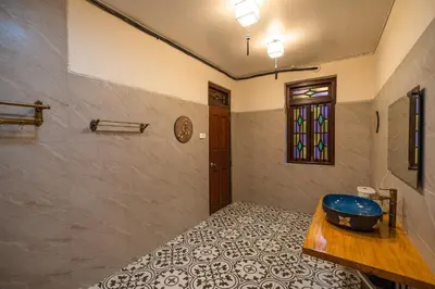 a bathroom with a blue tub in a room at LINN House Peranakan Residence George Town in George Town