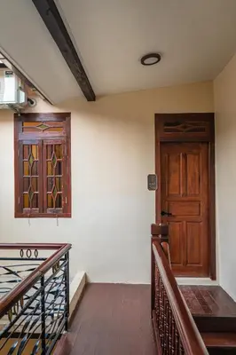 a room with a wooden door and a staircase at LINN House Peranakan Residence George Town in George Town