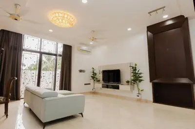 a living room with a couch and a tv at Gelugor 2Storey Big Bungalow 23pax with BBQ Snooker in Gelugor