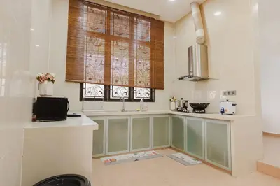 a kitchen with a counter and a window with a sink at Gelugor 2Storey Big Bungalow 23pax with BBQ Snooker in Gelugor