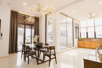 a dining room with a table and chairs and windows at Gelugor 2Storey Big Bungalow 23pax with BBQ Snooker in Gelugor