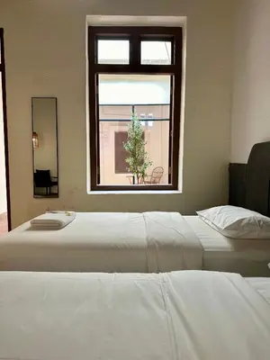 a bedroom with a large white bed and a window at Melayu Villa by Aayu - 8 mins walk to Armenian St in George Town