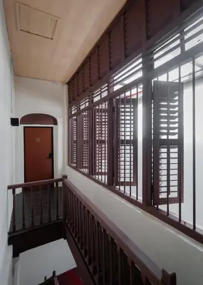 a hallway with wooden windows and a stairway at Melayu Villa by Aayu - 8 mins walk to Armenian St in George Town