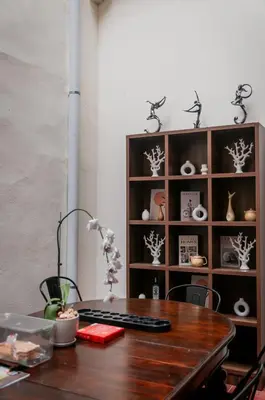 a desk with a keyboard and a shelf with vases at Melayu Villa by Aayu - 8 mins walk to Armenian St in George Town