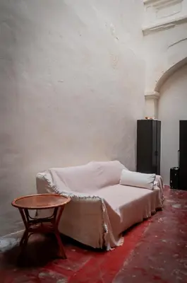 a bed sitting in a room with a table at Melayu Villa by Aayu - 8 mins walk to Armenian St in George Town