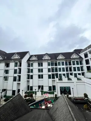 a large building with a pool in front of it at Lily Cameron-Tanah Rata in Tanah Rata