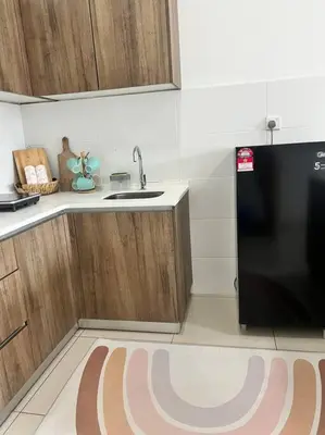 a kitchen with a sink and a black refrigerator at Lily Cameron-Tanah Rata in Tanah Rata