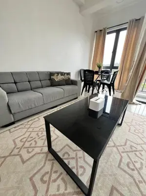 a living room with a couch and a table at Lily Cameron-Tanah Rata in Tanah Rata