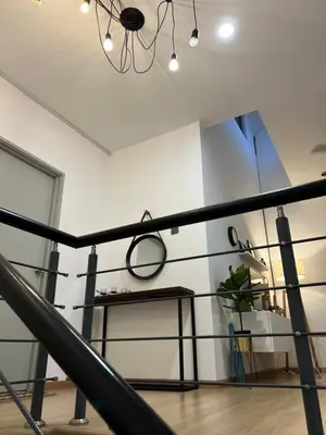a room with a black railing and a mirror at GardenView Home in Sungai Petani in Sungai Petani