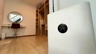 a white refrigerator in a room with a mirror at GardenView Home in Sungai Petani in Sungai Petani