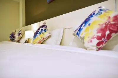 a row of pillows sitting on top of a bed at Hotel Mornington Bukit Permata Lumut in Lumut
