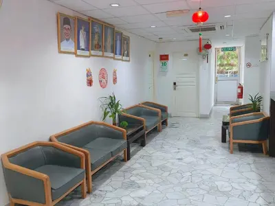 a waiting room with blue chairs and a corridor at Bahagia Stay Georgetown in George Town